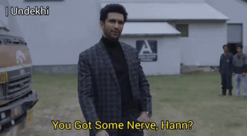 Man in Suit and Turtleneck Talking