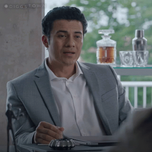 Man in Suit and White Shirt at Table
