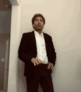 Man In Suit And White Shirt Standing Hallway GIF