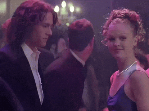 Man in Suit and Woman in Blue Dress Dancing