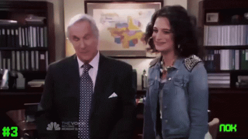 Man in Suit and Woman in Denim Jacket Next to #3 Screen