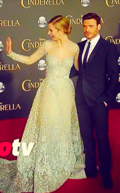 Man In Suit And Woman In Dress On Cinderella Red Carpet GIF