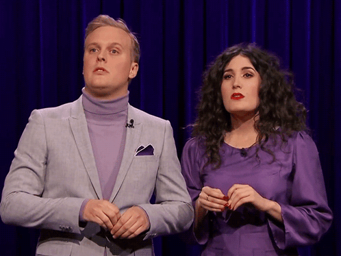 Man In Suit And Woman In Purple Dress GIF