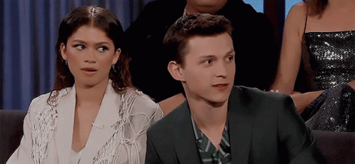Man In Suit And Woman In White Jacket Sitting Together GIF