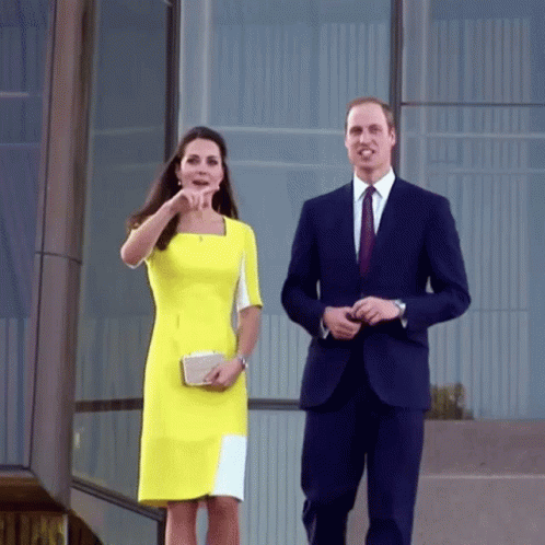 Man In Suit And Woman In Yellow Dress Walking GIF