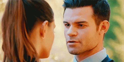 Man In Suit And Woman Looking At Each Other GIF
