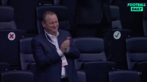 Man in Suit Applauding in Stadium