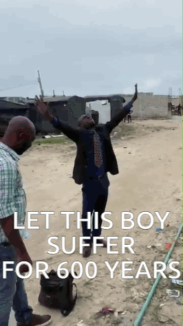 Man in Suit Arms Up Another Man Behind