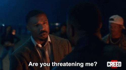 Man in Suit Asking Are You Threatening Me