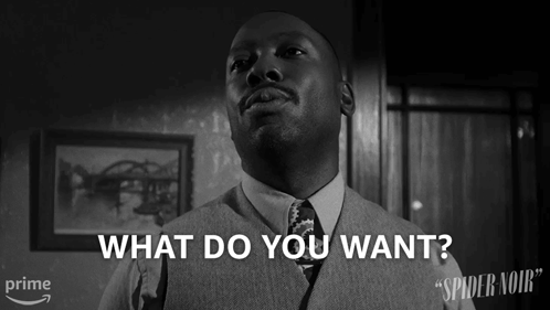 Man in Suit Asking What Do You Want Black White