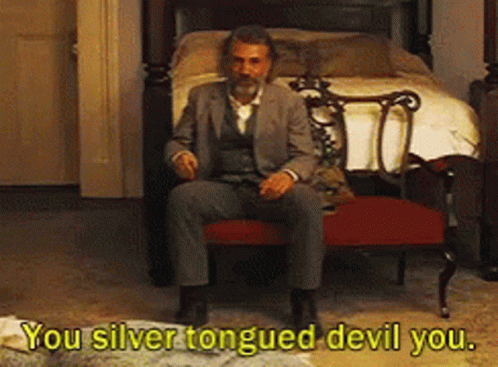 Man in Suit at Bed Saying You Silver Tongued Devil You