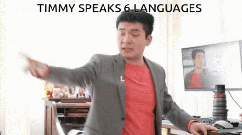 Man In Suit At Computer Saying Timmy Speaks 6 Languages GIF
