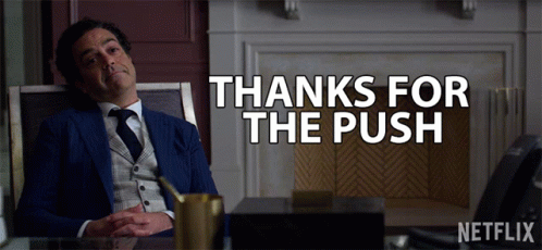 Man in Suit at Desk Saying Thanks for the Push