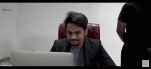 Man In Suit At Desk With Unlimited Laptop GIF