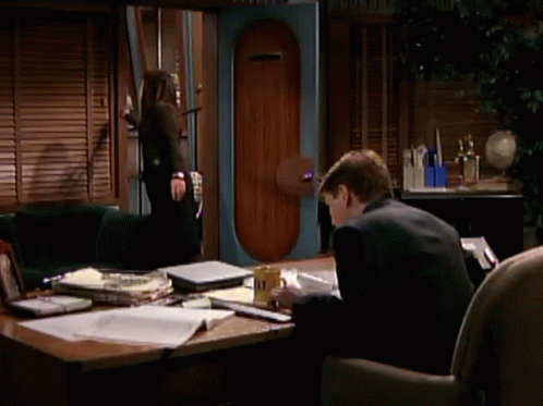 Man In Suit At Desk With Yellow A & N Mug GIF
