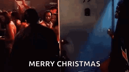 Man In Suit At Door In Crowded Room GIF
