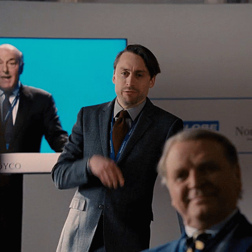 Man In Suit At Joyco Podium GIF