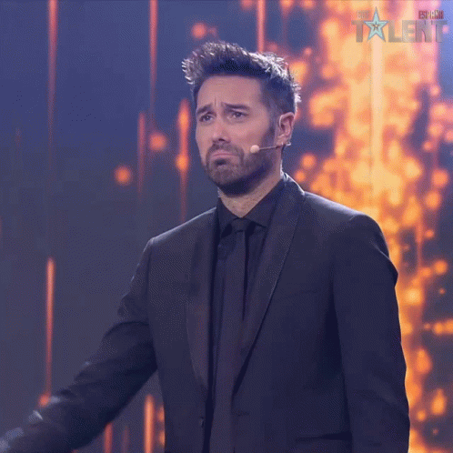 Man in Suit at Microphone with Talent