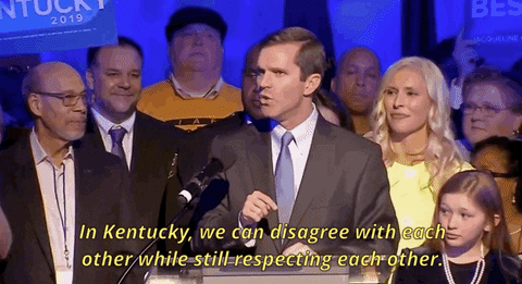 Man In Suit At Podium Says In Kentucky GIF
