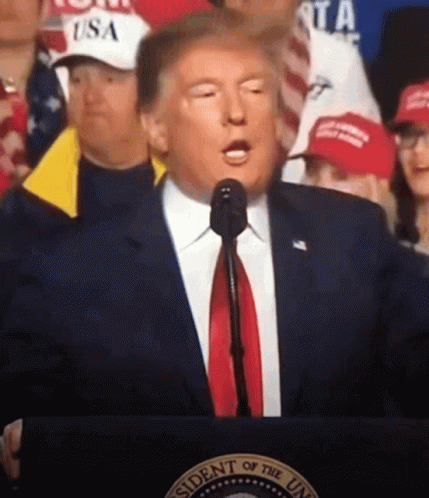 Man in Suit at Podium With Presidential Seal