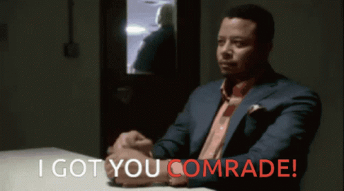 Man In Suit At Table With I Got You Comrade In Red GIF