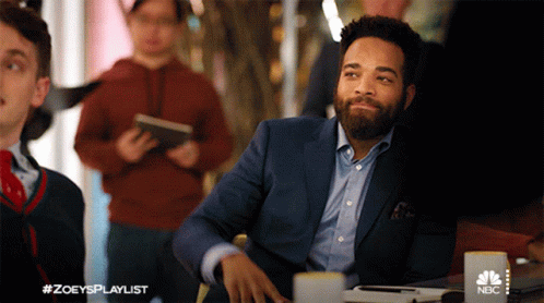Man in Suit at Table With NBC