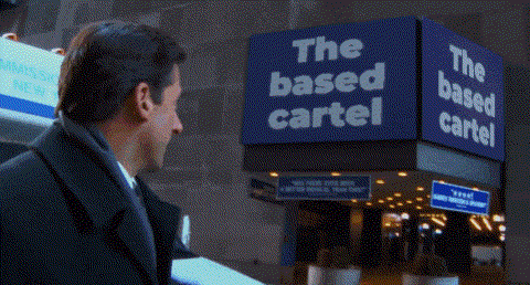 Man in Suit at The Based Cartel Sign