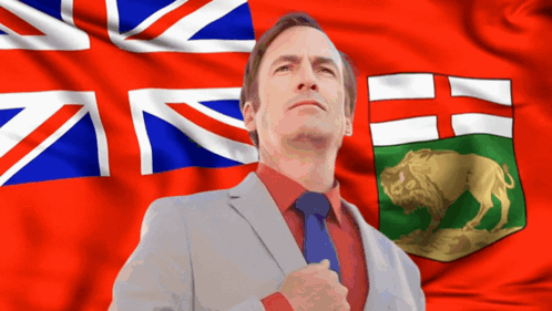 Man in Suit Before British and Canadian Flags