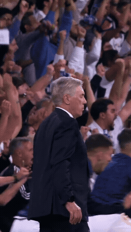Man In Suit Before Crowd Arms Up GIF