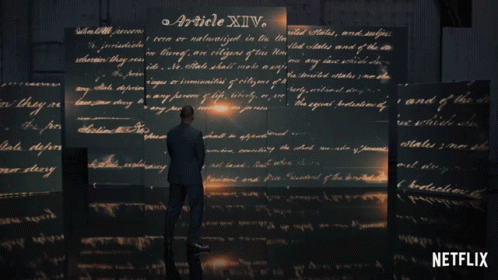 Man in Suit Before Wall of Handwritten Article XIV