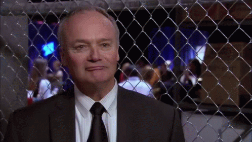 Man in Suit Behind Fence