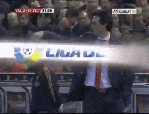 Man in Suit Beside Livad Sign