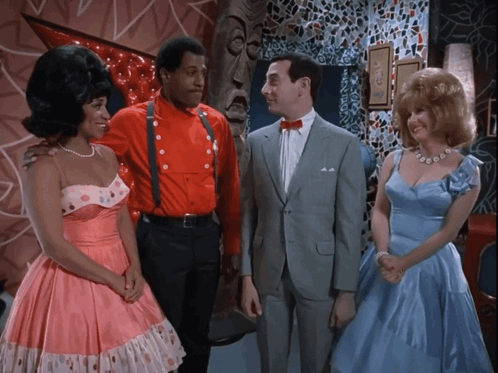 Man In Suit Between Women In Pink And Man In Red GIF