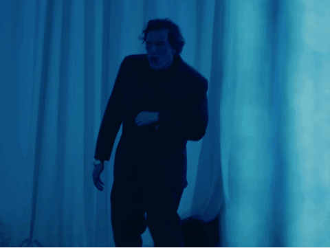 Man in Suit by Blue Wall