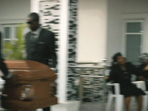 Man In Suit Carrying Coffin Blurry Photo GIF