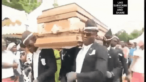 Man in Suit Carrying Coffin on Head