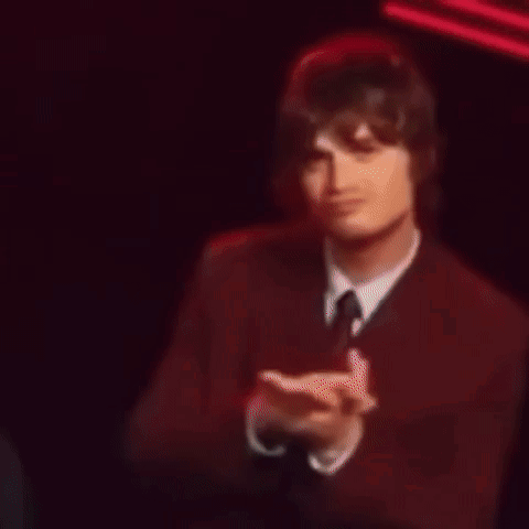 Man in Suit Clapping by Building with B