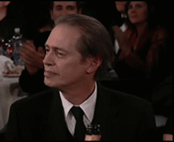 Man in Suit Clapping in Crowd