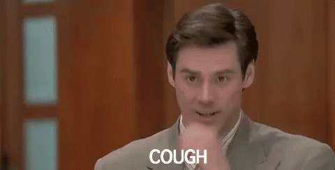 Man In Suit Coughing While Sitting In Chair GIF