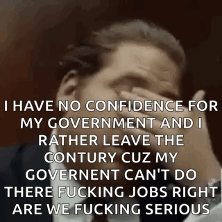 Man in Suit Covering Face and Making Funny Face