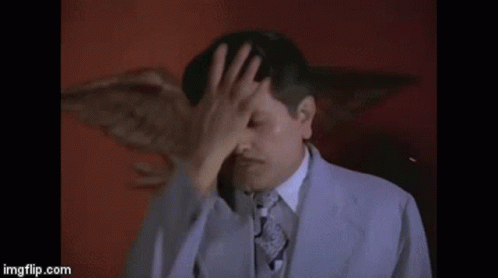 Man In Suit Covering Face GIF