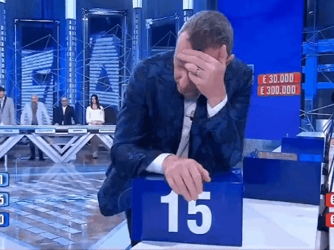 Man In Suit Covering Face Playing Game With Number 15 GIF