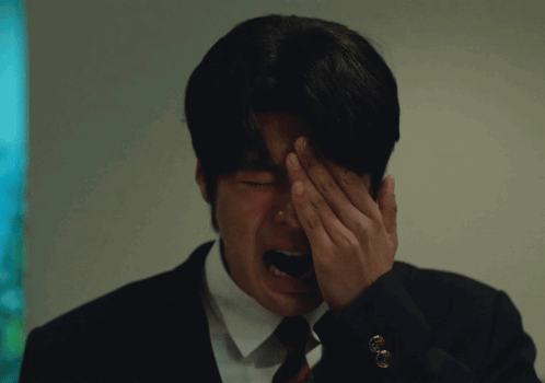 Man In Suit Covering Face With Hand GIF