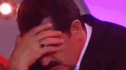 Man in Suit Covering Face With Wedding Ring