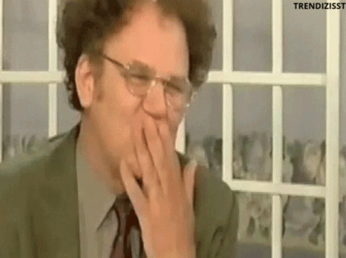 Man In Suit Covering Mouth Laughing GIF
