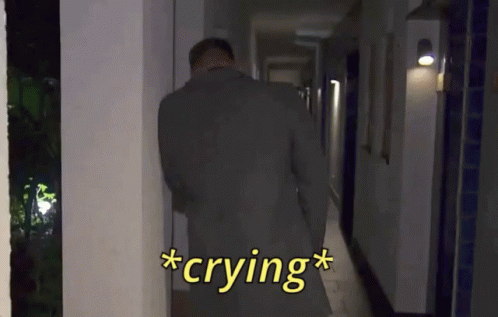 Man in Suit Crying in Hallway at Night