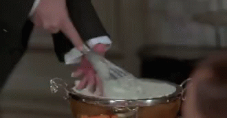 Man In Suit Cutting Cake With Scissors GIF