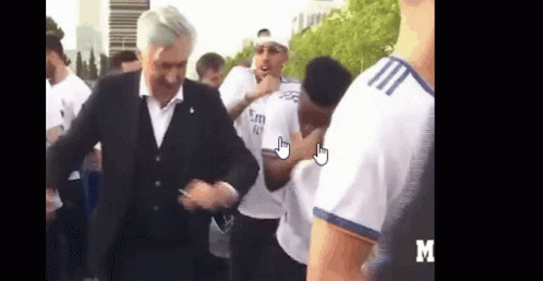 Man in Suit Dancing Before Group