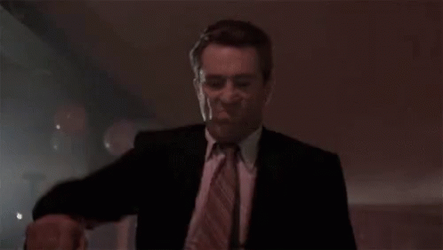 Man in Suit Dancing in Dark Club