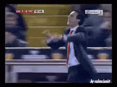 Man in Suit Dancing in Front of TV Saying NFC